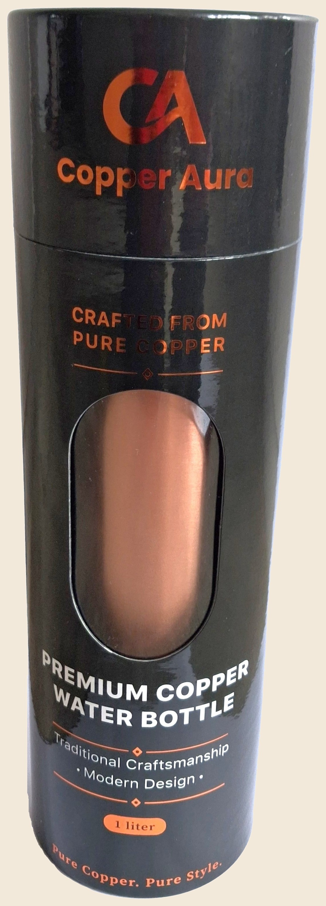 The Copper Aura bottle in its black presentation tube, the copper showing through the window